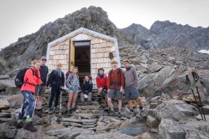 Gran Paradiso hikers posing in front of a small mountain hut