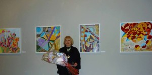 Lea Ricci Turin Artist in front of her paintings at an art exhibit in Turin