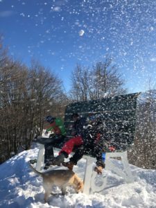 Big Bench in Piedmont with adults sitting on it having a snowball fight